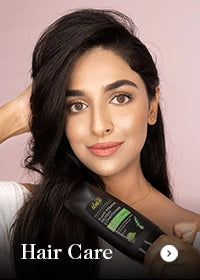 Woman holding a bottle of Dabur Vatika hair care product with text 'Hair Care' on a pink background