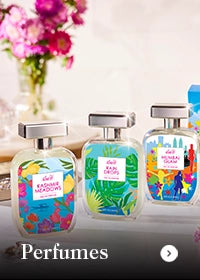 Three perfume bottles with colorful labels on a reflective surface.